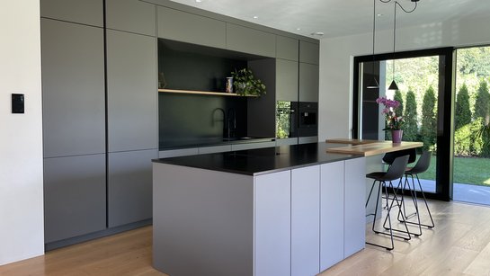 Die basaltgraue Hochschrankzeile wurde deckenhoch verbaut.