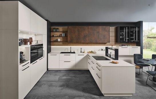 Helle U-förmige Küche mit bronzefarbigen griffen und Oberschränken in patina bronze.