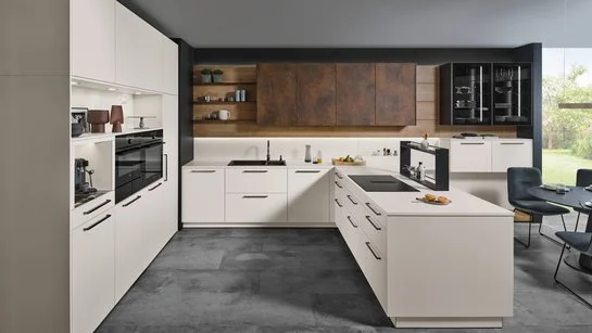 Helle U-förmige Küche mit bronzefarbigen griffen und Oberschränken in patina bronze.