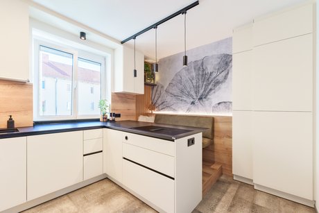 Moderne Küche mit großzügiger Arbeitsfläche, dezent integrierten Steckdosen und perfekt abgestimmtem Materialmix.