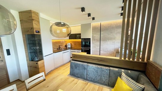 Moderne ewe nanoo® Küche in kieselgrau mit Hochschränken in Betonoptik.